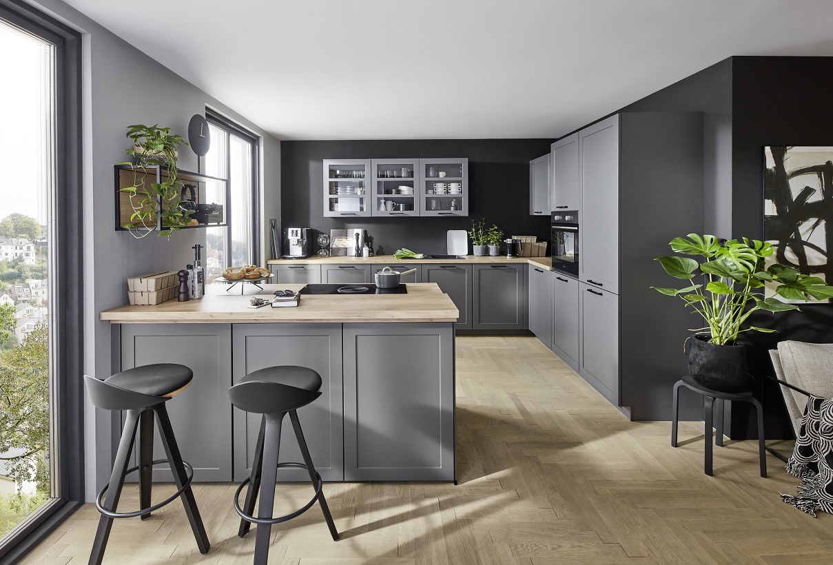 Normandie rustic kitchen with green framed fronts and wooden accents